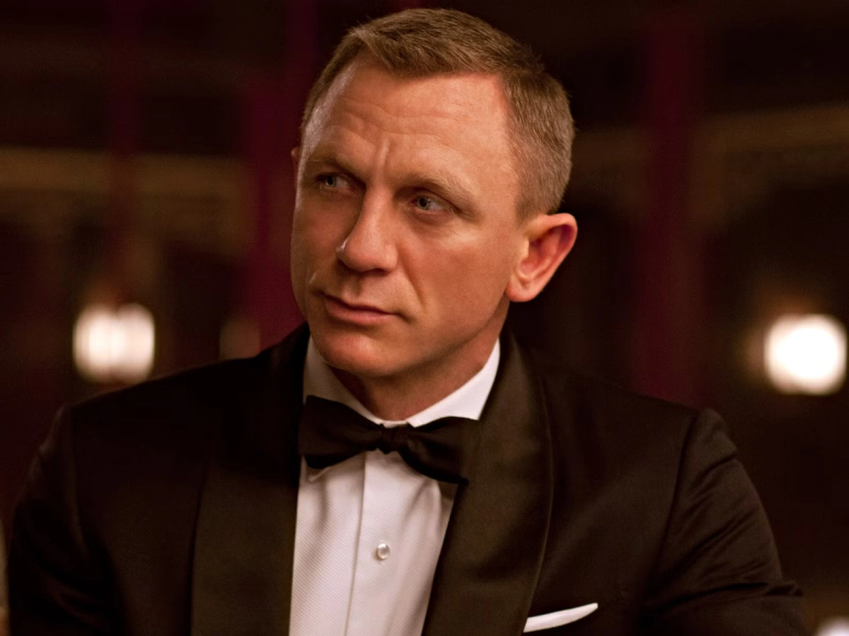 Daniel Craig Theo trang DenofGeek, vào tháng 10/2005, thông tin Daniel Craig đóng James Bond vấp phải phản ứng do ngoại hình khác biệt so với hình tượng 007 truyền thống. Với mái tóc vàng, mắt xanh và vẻ ngoài gai góc, tài tử người Anh không mang dáng dấp điệp viên lịch lãm, tóc đen ở các phần trước. Ông đảm nhận vai nam chính từ Casino Royale (2006), mở ra góc nhìn mới về nhân vật. Phim No Time to Die (2021) là lần cuối diễn viên vào vai điệp viên 007. Trước khi nổi tiếng với loạt phim, Craig gây chú ý qua series truyền hình Our Friends in the North của BBC năm 1996. Ông còn được biết đến qua các tác phẩm như The Girl With the Dragon Tattoo, The Adventures of Tintin và nhất là vai thám tử Benoit Blanc trong series Knives Out. Craig từng kết hôn diễn viên Fiona Loudon và có một con gái trước khi ly hôn năm 1994. Sau nhiều mối tình, ông cưới mỹ nhân phim Xác ướp Ai Cập Rachel Weisz năm 2011. Cả hai kín tiếng về đời sống gia đình, có một con gái chung hiện tám tuổi. Sau Daniel Craig, hiện nhà sản xuất trong giai đoạn tuyển chọn gương mặt kế tiếp để vào vai điệp viên James Bond cho phần phim thứ 26, do Denis Villeneuve đạo diễn. Ảnh: MGM/Columbia Pictures