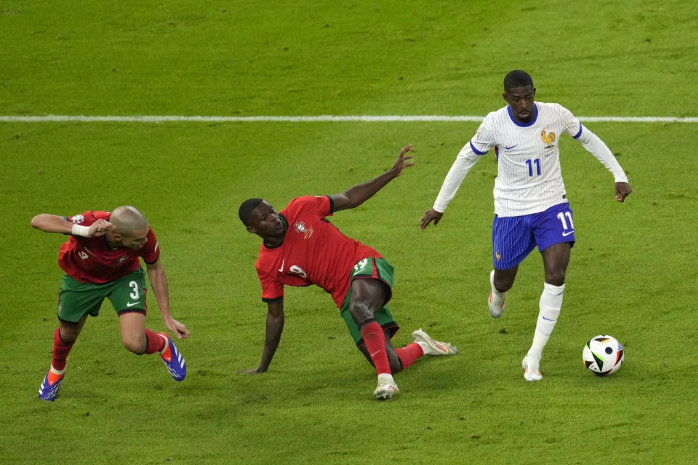 Tiền đạo Pháp Ousmane Dembele đi bóng qua hậu vệ Bồ Đào Nha Nuno Mendes trong trận tứ kết Euro 2024 trên sân Hamburg, Đức ngày 5/7. Ảnh: AP
