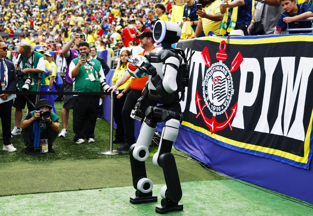 Robot hình người Atlas của Boston Dynamics mang quả bóng ra sân MetLife trước khi hiệp hai của trận Brazil - Na Uy vòng 1/8 World Cup bắt đầu. Ảnh: Reuters