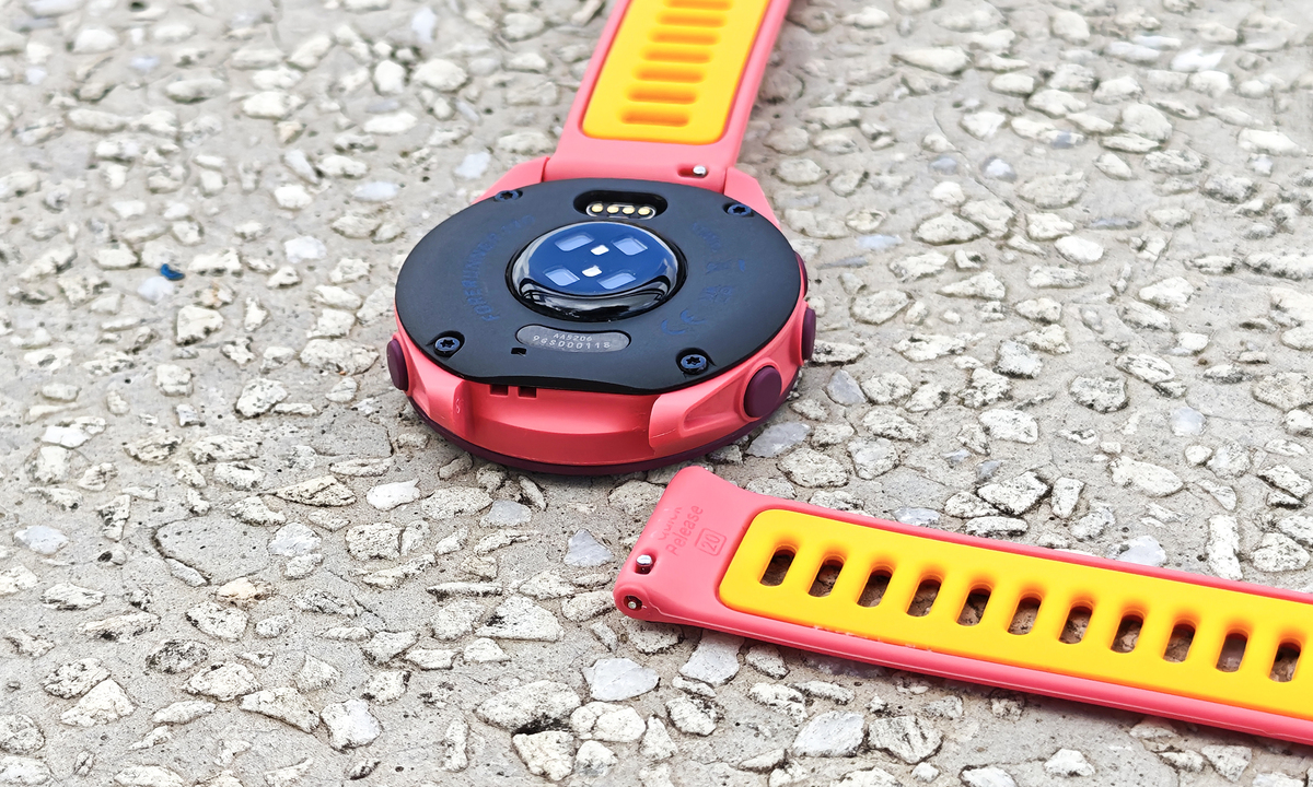 Smartwatch của Garmin sử dụng dây silicon kích cỡ 20 mm với chốt thông minh Quick Release khá phổ biến, người dùng có thể dễ dàng thay dây theo sở thích. Trải nghiệm dây đeo mang lại cảm giác thoải mái cả khi luyện tập thể thao lẫn dùng hằng ngày. Mặt sau gồm cổng sạc và hệ thống cảm biến. Garmin vẫn tích hợp cổng sạc với chuẩn riêng bằng kết nối vật lý thay vì sạc không dây.